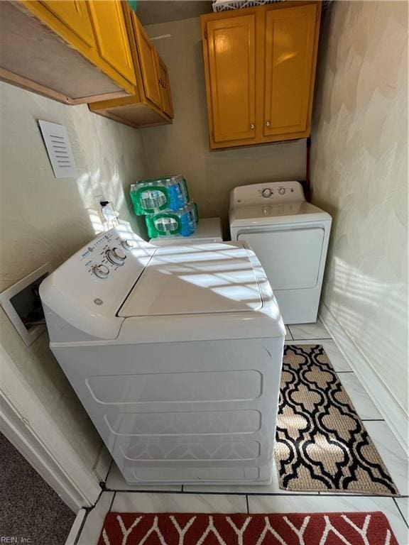 laundry room with washer and clothes dryer and cabinet space