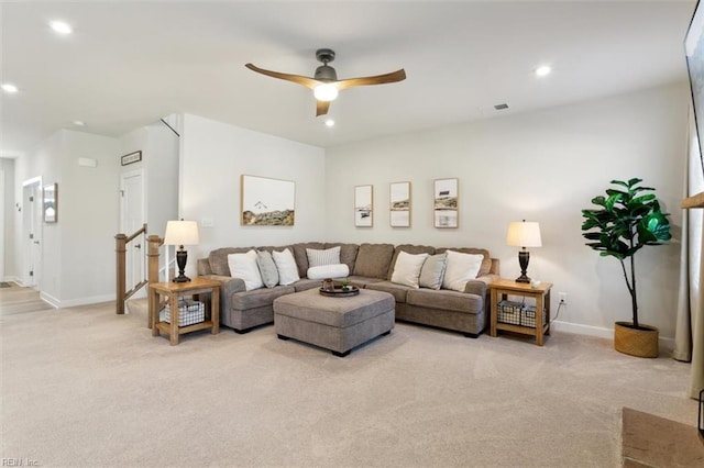 living area with a ceiling fan, recessed lighting, light carpet, and baseboards