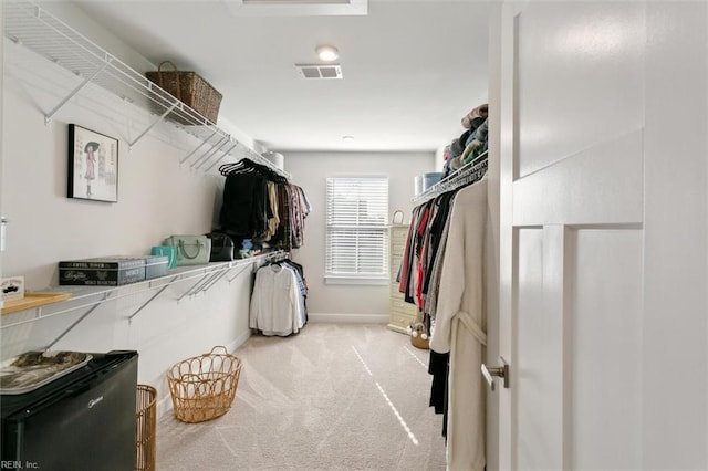 walk in closet featuring carpet and visible vents