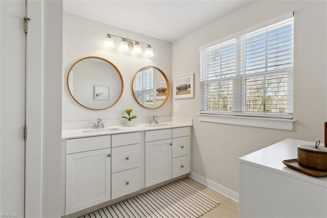 full bathroom with tile patterned floors, a sink, baseboards, and double vanity