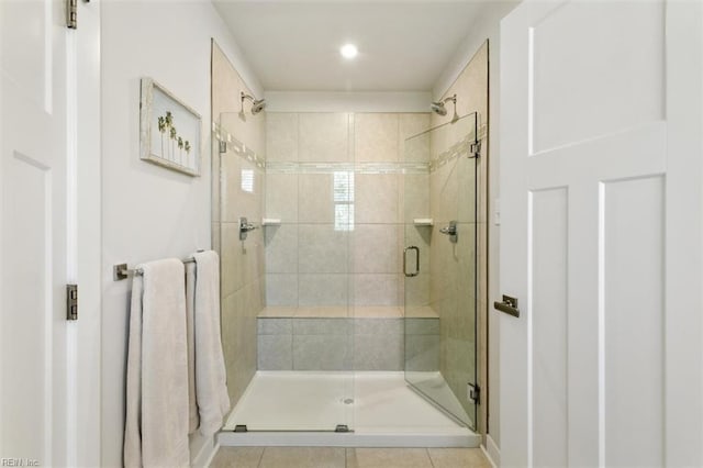 bathroom featuring tile patterned flooring and a shower stall