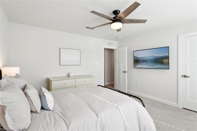 carpeted bedroom with ceiling fan, visible vents, and baseboards