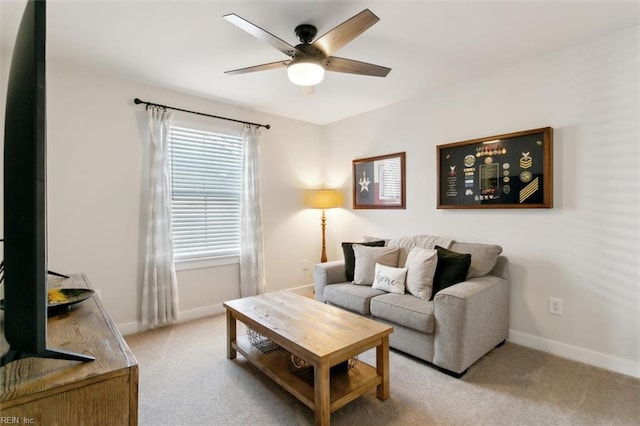 living room featuring ceiling fan, carpet floors, and baseboards