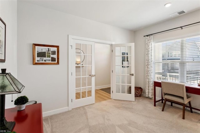 office area with carpet floors, french doors, visible vents, and baseboards