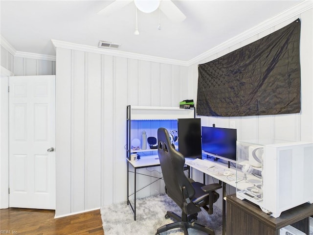 home office with ornamental molding, visible vents, ceiling fan, and wood finished floors