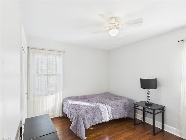 bedroom featuring baseboards, a ceiling fan, and wood finished floors