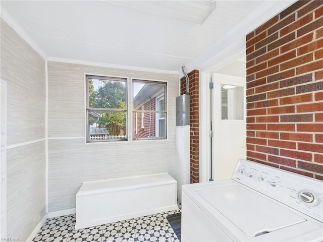 laundry room featuring brick wall, ornamental molding, washer / dryer, and tile patterned floors