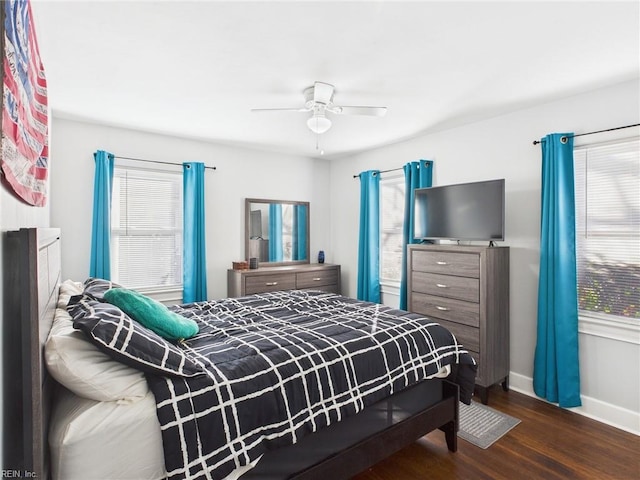 bedroom featuring ceiling fan, baseboards, and wood finished floors