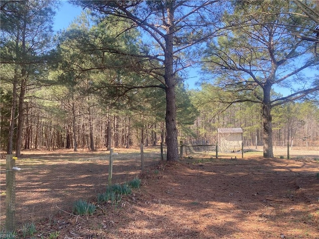 view of yard featuring a forest view