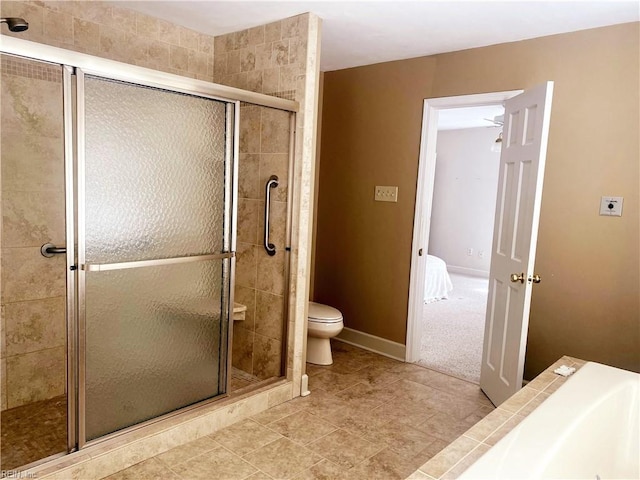 full bath featuring a stall shower, baseboards, toilet, and tile patterned floors