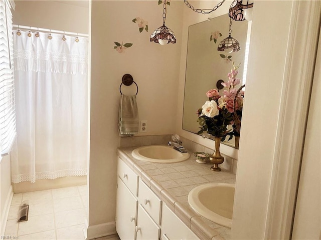 bathroom featuring double vanity, a shower with curtain, and a sink