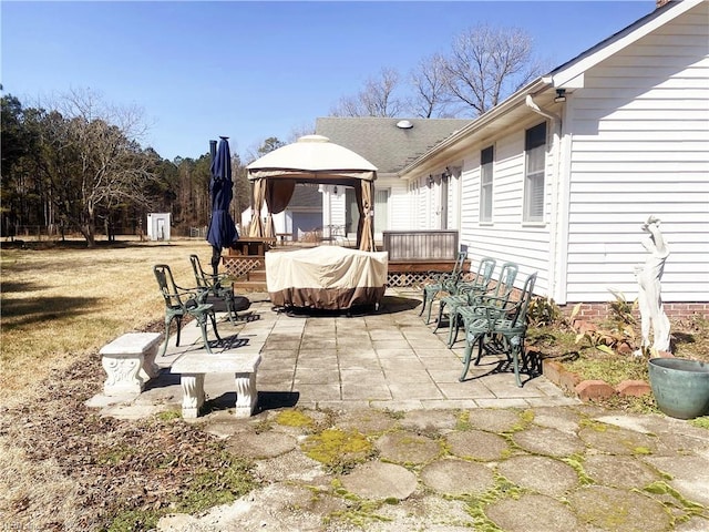 view of patio / terrace with a wooden deck and a gazebo