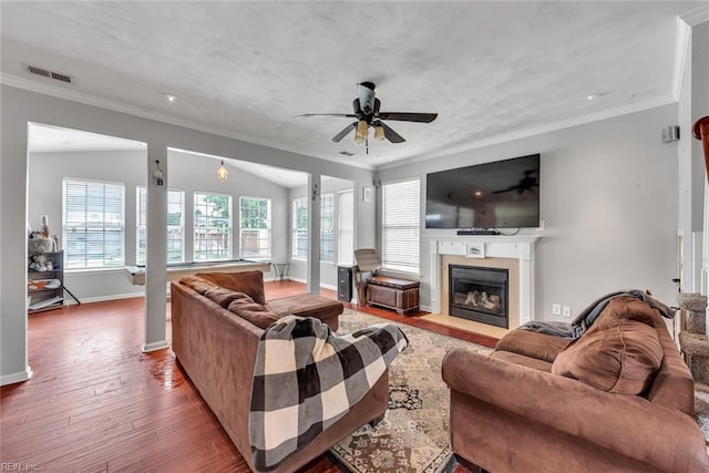 living area featuring ornamental molding, visible vents, and plenty of natural light