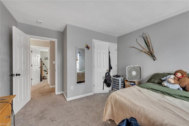 bedroom featuring a closet, carpet, and baseboards