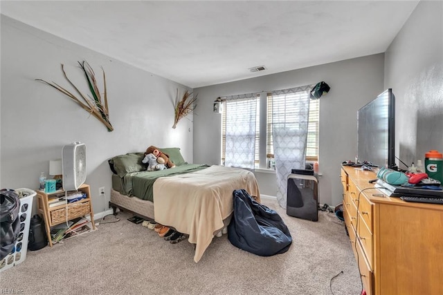 carpeted bedroom with baseboards and visible vents