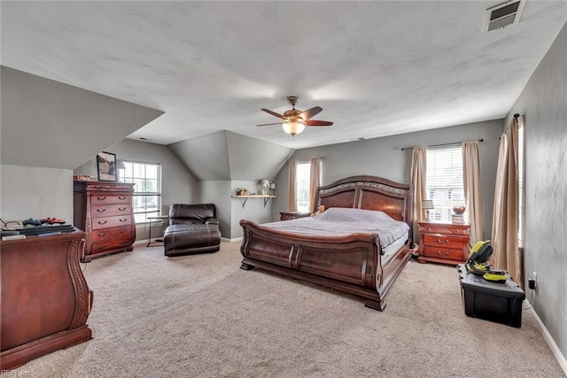 bedroom with carpet, multiple windows, baseboards, and vaulted ceiling