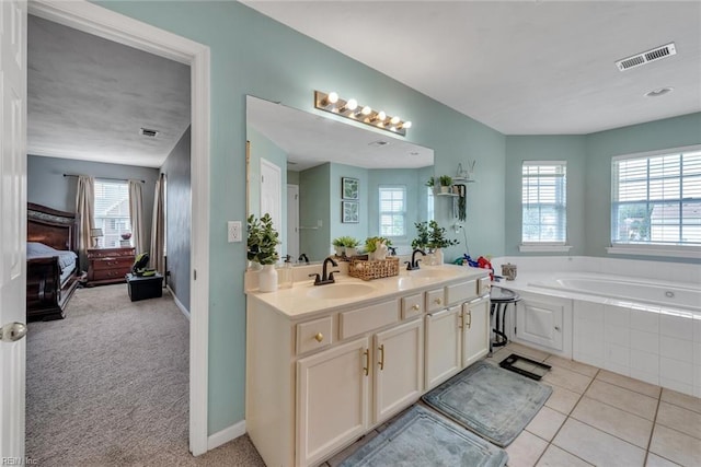 full bath featuring a wealth of natural light, visible vents, and a sink