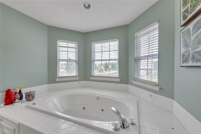 bathroom with a whirlpool tub and plenty of natural light