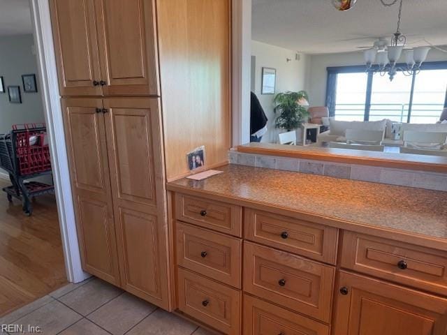 kitchen with light countertops, a notable chandelier, and light tile patterned flooring