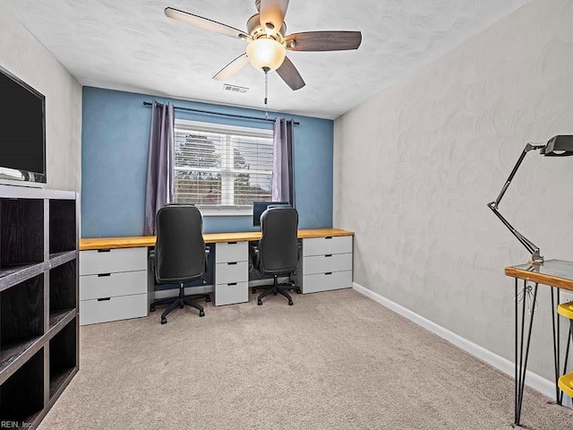 office area with ceiling fan, a textured ceiling, carpet floors, visible vents, and baseboards