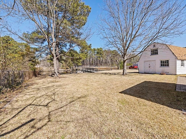 view of yard featuring an outbuilding and fence