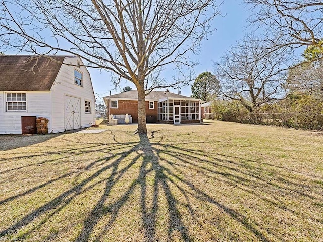 view of yard featuring an outbuilding, a sunroom, and a barn