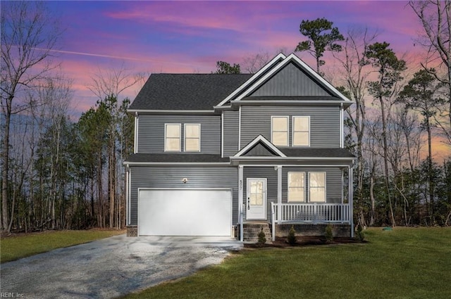 view of front of property featuring driveway, covered porch, an attached garage, and a front lawn