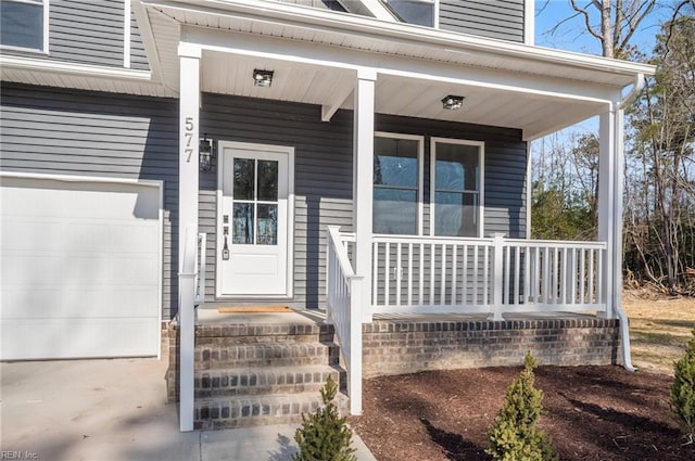 doorway to property with a porch and a garage