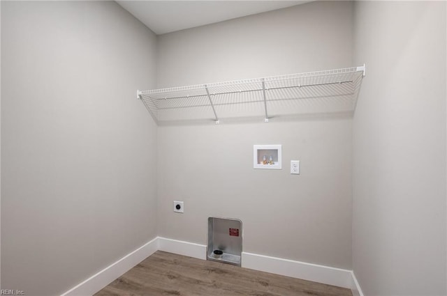 laundry area featuring hookup for an electric dryer, laundry area, washer hookup, wood finished floors, and baseboards