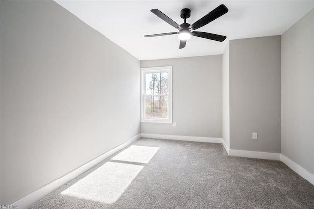 carpeted empty room with baseboards and a ceiling fan