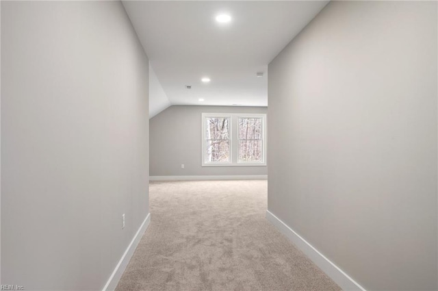 hall with vaulted ceiling, recessed lighting, carpet flooring, and baseboards