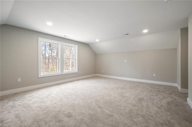 additional living space featuring lofted ceiling, carpet floors, and baseboards