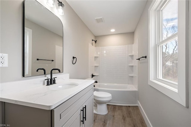 full bath featuring plenty of natural light, vanity, toilet, and wood finished floors