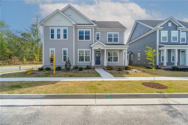 view of front of house featuring board and batten siding and a front yard