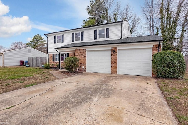 traditional home with brick siding, driveway, and fence