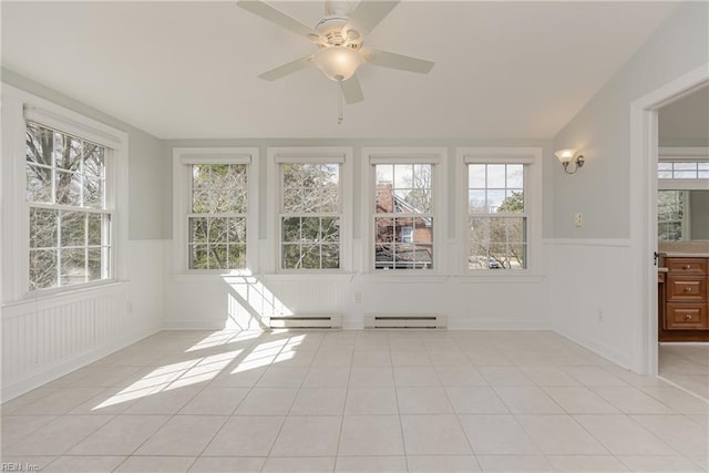 unfurnished sunroom featuring ceiling fan and a baseboard radiator