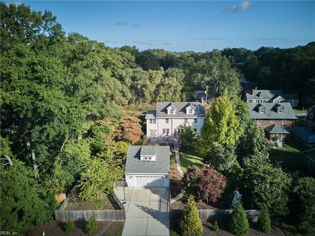 drone / aerial view featuring a wooded view