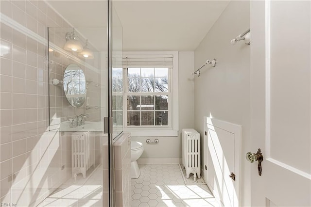 bathroom featuring toilet, radiator, tile patterned flooring, baseboards, and vanity