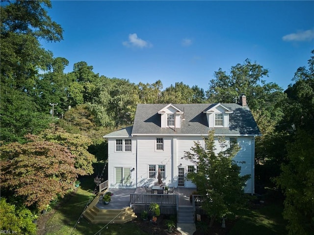 view of front of home featuring a wooden deck and a chimney