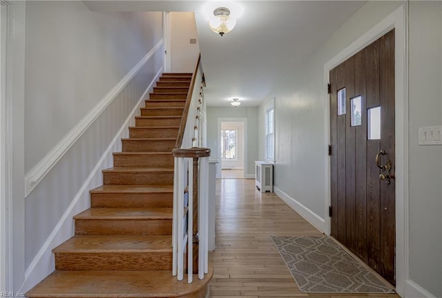 interior space with baseboards and wood finished floors