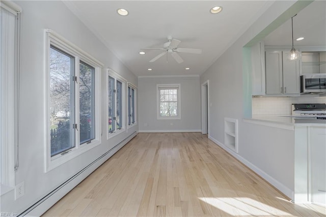 unfurnished living room with a baseboard radiator, light wood-style floors, ceiling fan, and crown molding