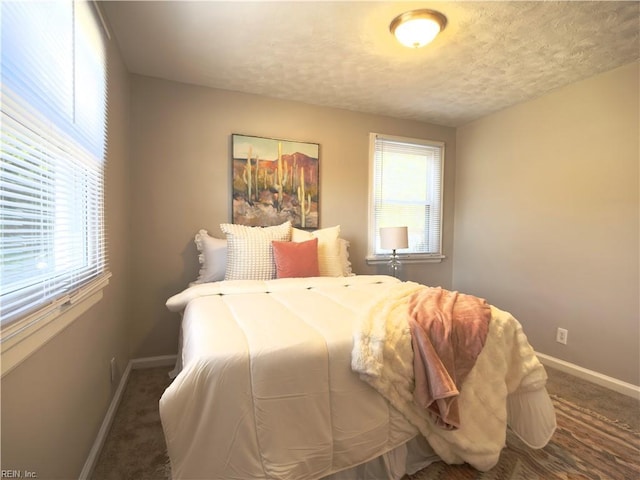 bedroom with carpet floors, multiple windows, and baseboards