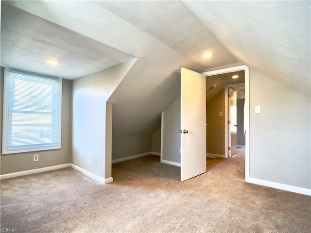 additional living space with lofted ceiling, recessed lighting, carpet, and baseboards