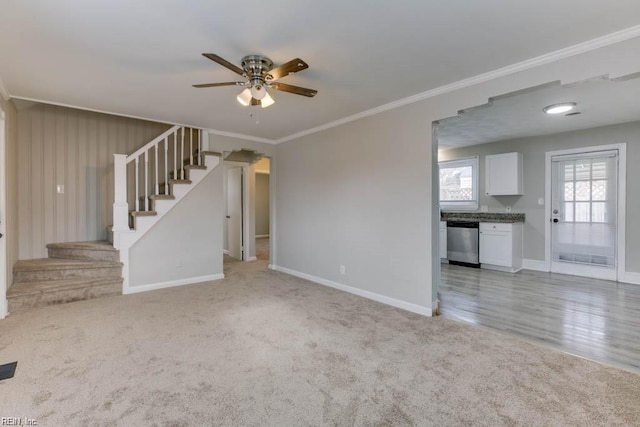 unfurnished living room featuring stairs, ornamental molding, and light colored carpet