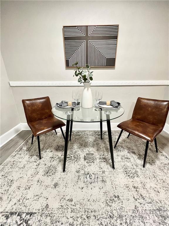 sitting room with wood finished floors and baseboards