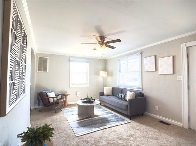 living area with baseboards, carpet, visible vents, and crown molding