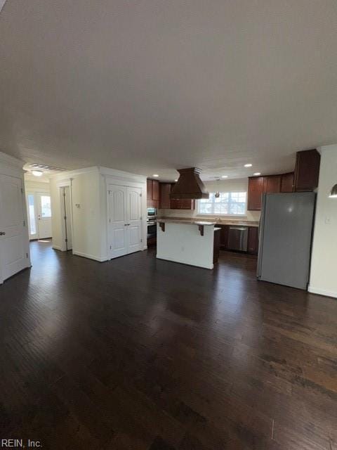 unfurnished living room with dark wood-style floors and baseboards