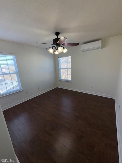 unfurnished room featuring dark wood-type flooring, a ceiling fan, baseboards, and a wall mounted AC