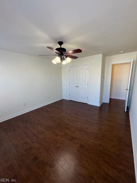 unfurnished bedroom with ceiling fan, a closet, baseboards, and dark wood-style flooring