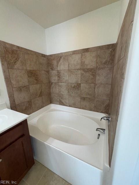 bathroom featuring a garden tub, tile patterned floors, and vanity